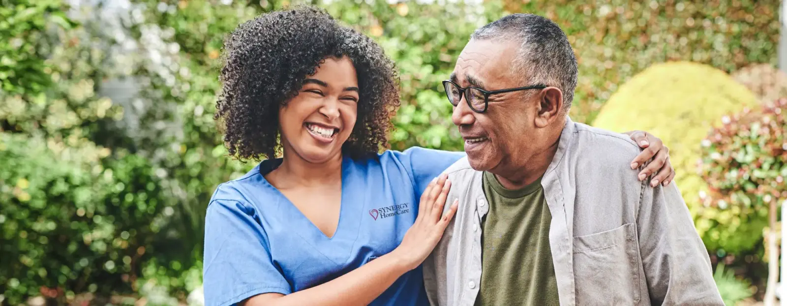 Caregiver smiling and embracing client