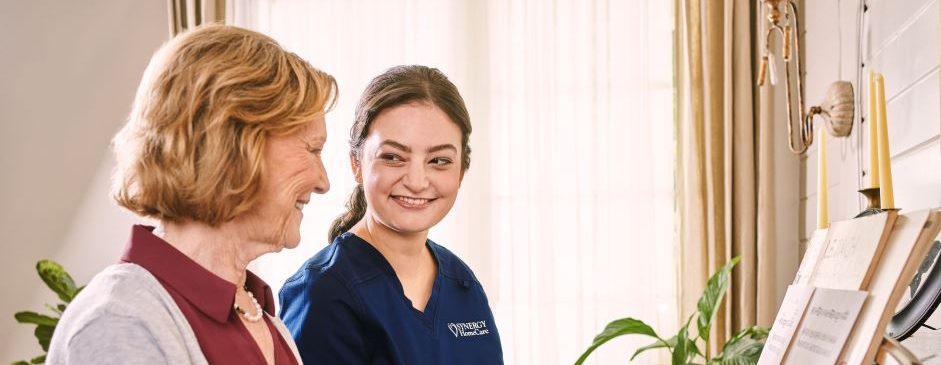 SYNERGY HomeCare Caregiver playing piano with senior.