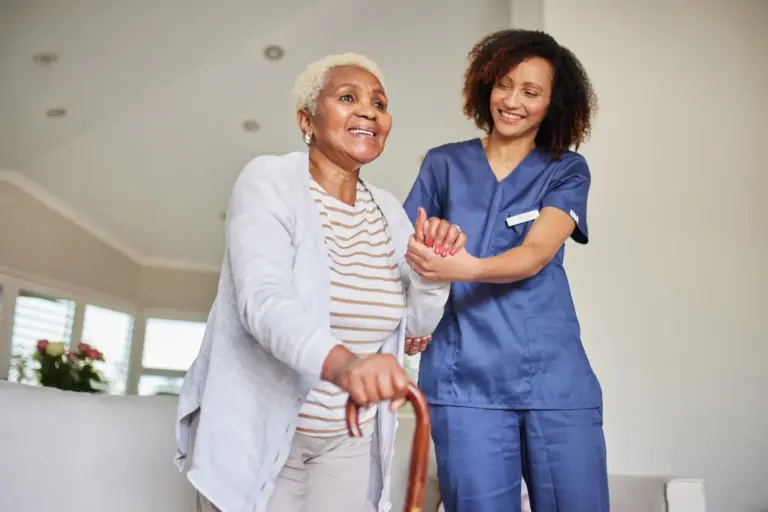 caregiver helping senior walk