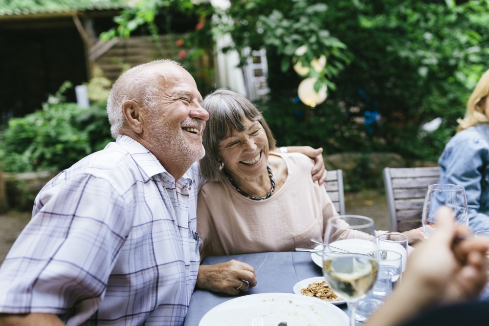 Senior couple hugging on their patio