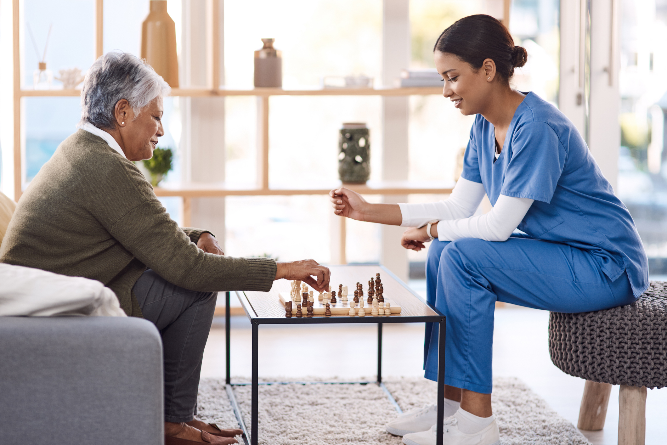 SYNERGY HomeCare Caregiver and client playing chess
