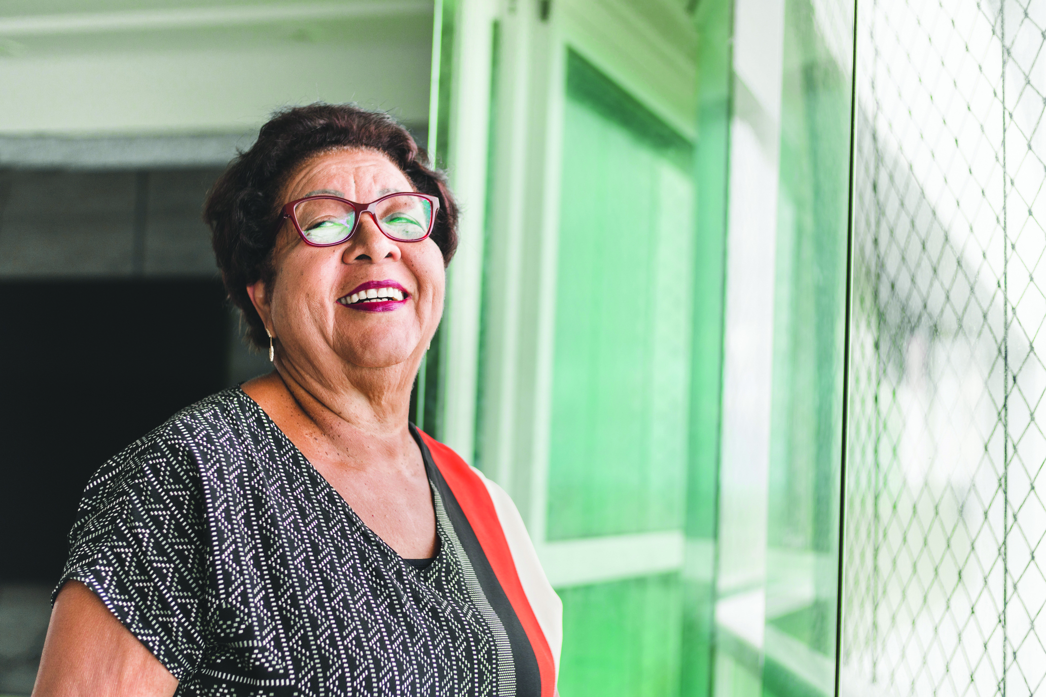 SYNERGY HomeCare client smiling looking out the windo.