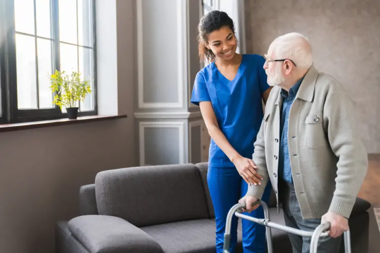 SYNERGY HomeCare caregiver helping client walk