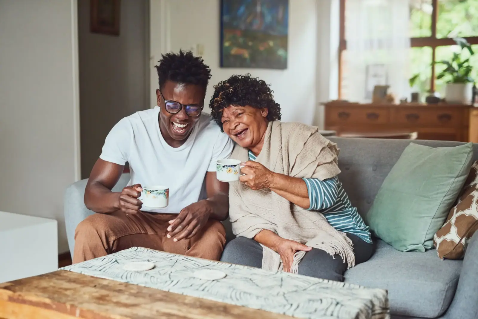 A son and mother laughing.