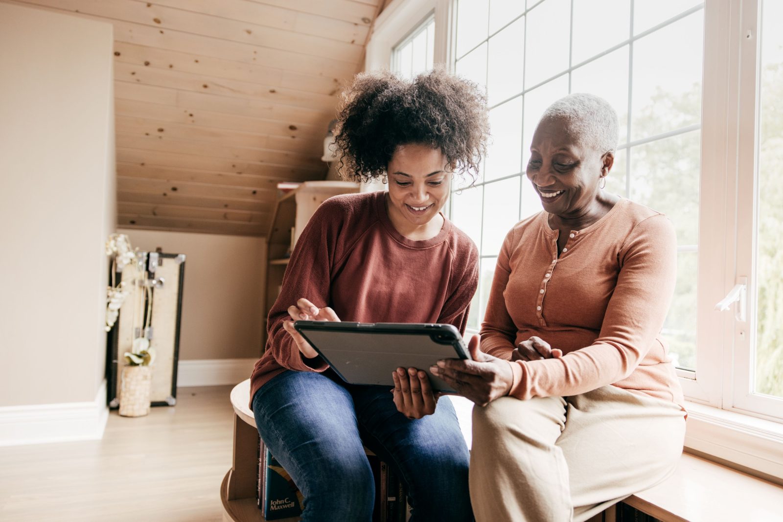 Senior woman and her daughter exploring home care cost.