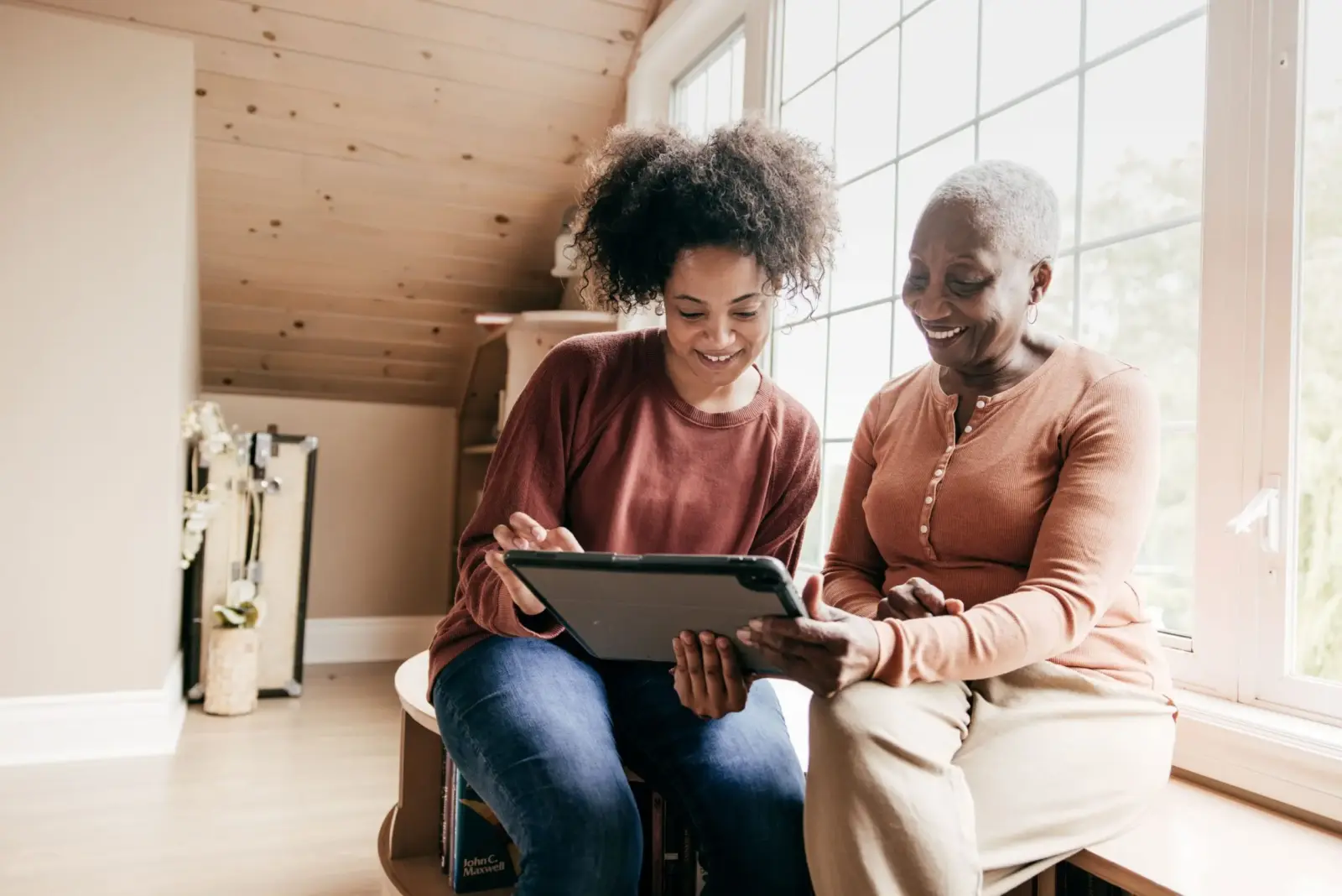 Senior woman and her daughter exploring home care cost.