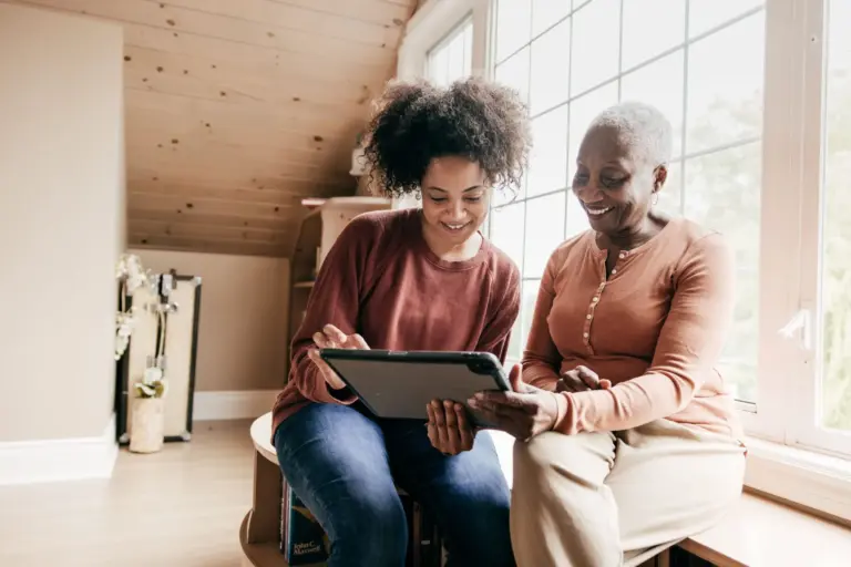 Senior woman and her daughter exploring home care cost.