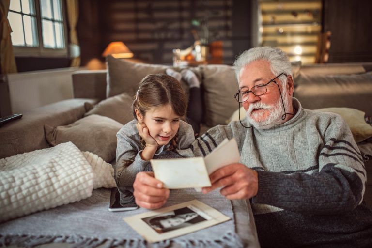 Grandad showing her granddaughter memories from past