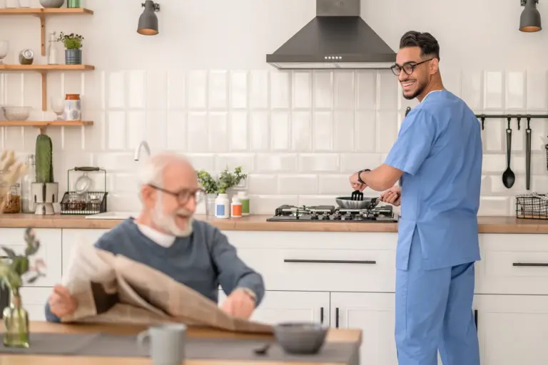 SYNERGY HomeCare caregiver helping client with cooking