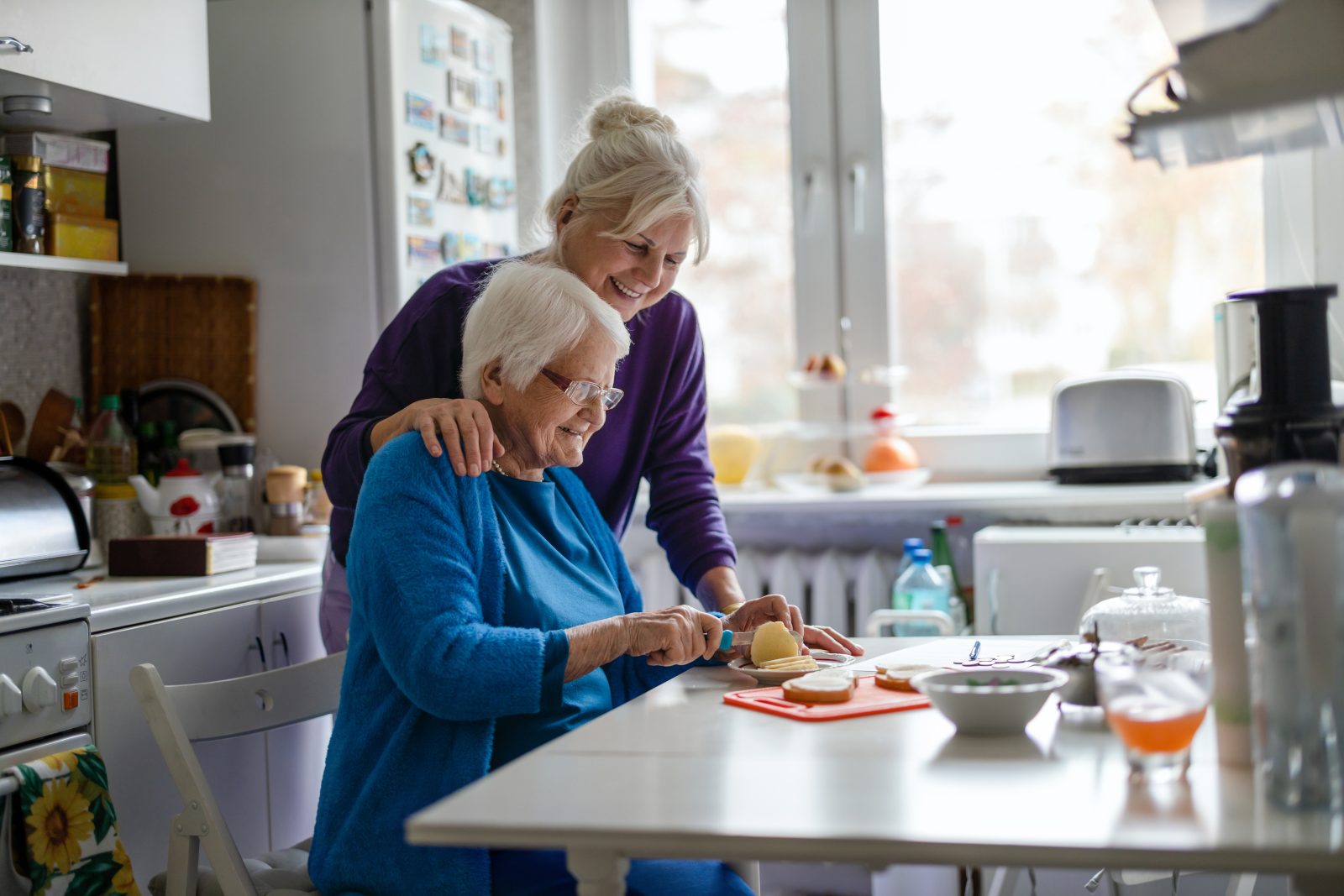Helping a senior cut food.