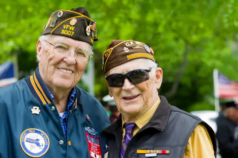 Two senior veterans smiling, highlighting military benefits for family