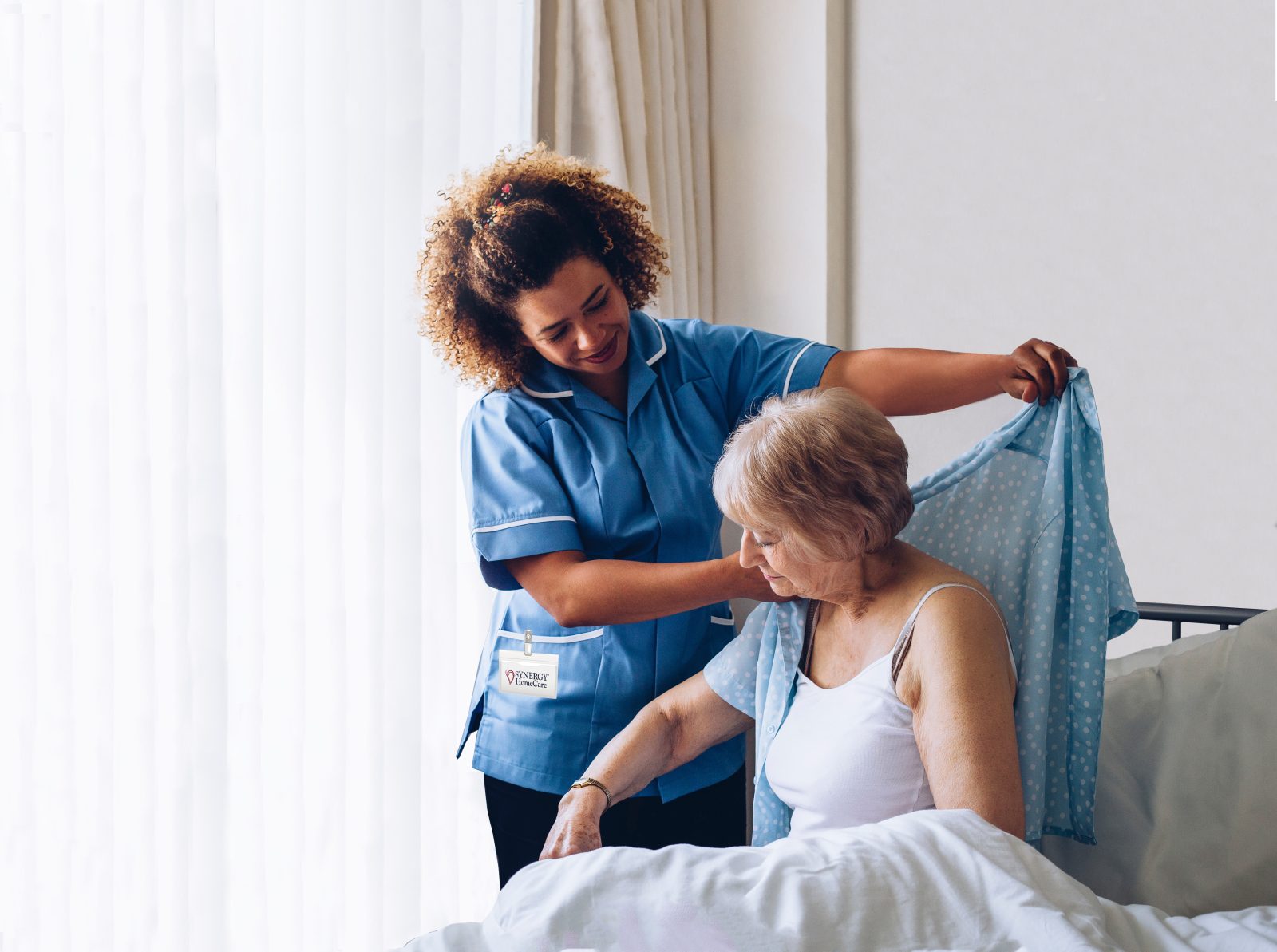 Happy caregiver and client sharing a moment at home