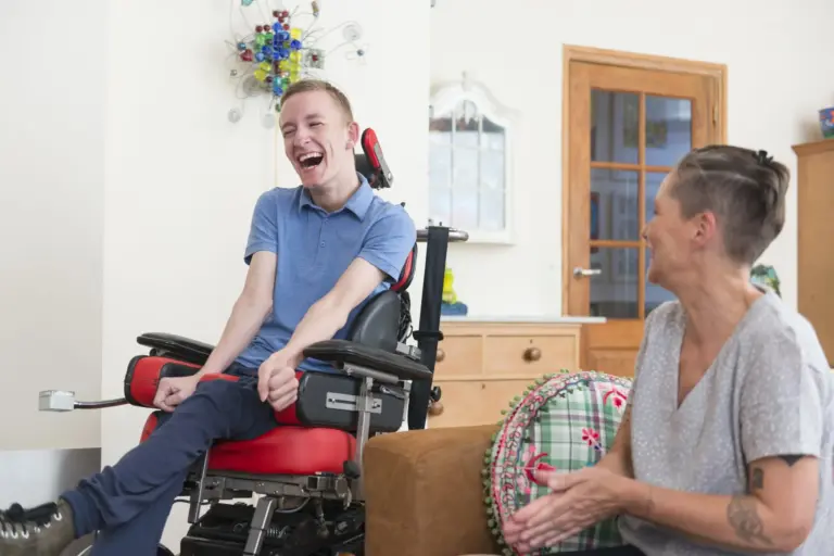 Happy young ALS patient with his mom
