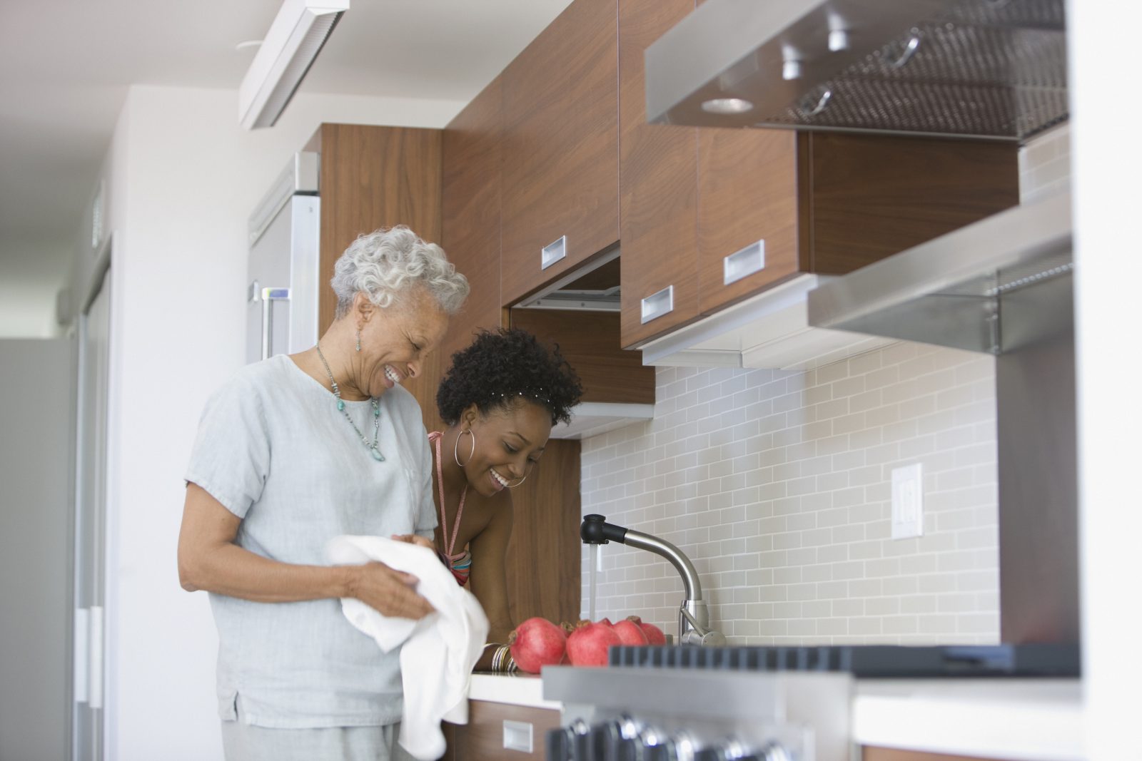 Grandmother and granddaughter preparing food in kitchen