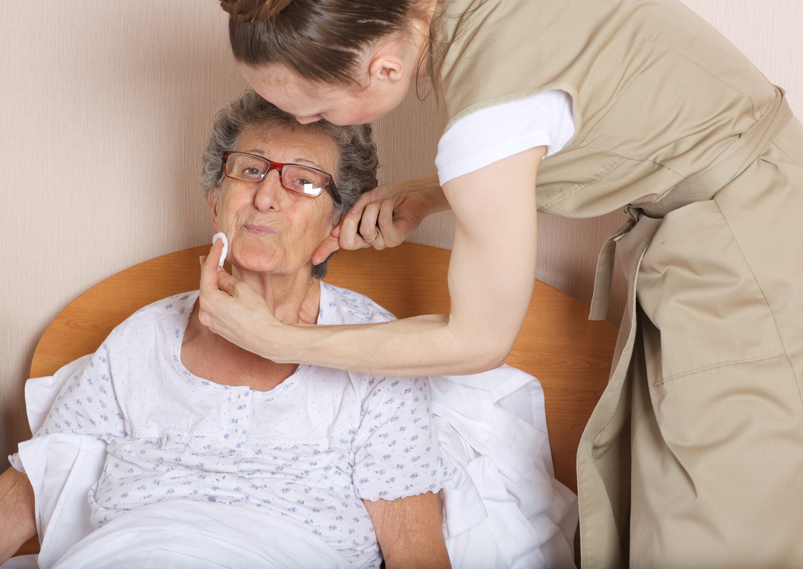Young social work assistant takes care of a senior woman between 70 and 80 years old.