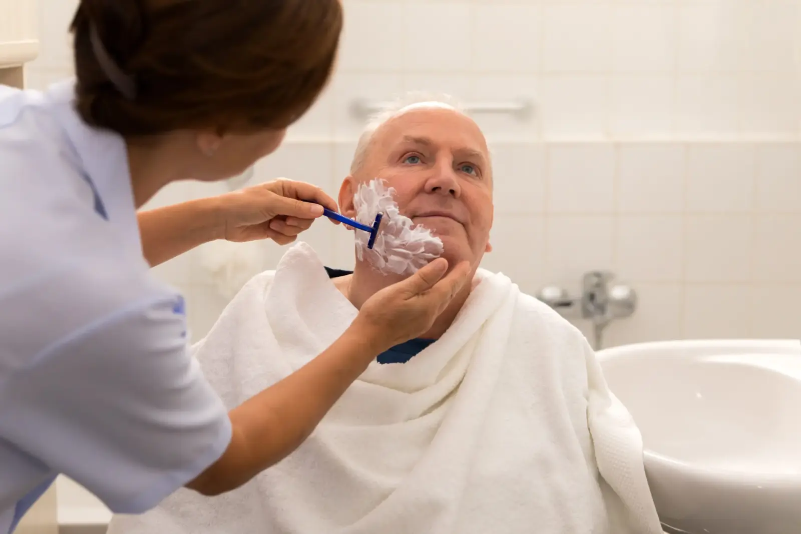 Personal hygiene – home caregiver with senior man in bathroom