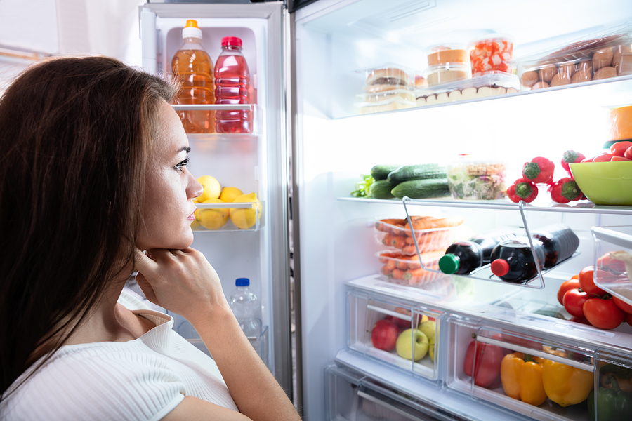 Pretty Woman Looking For Food In Refrigerator