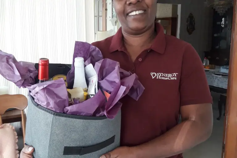 judith smiling holding a gift basket