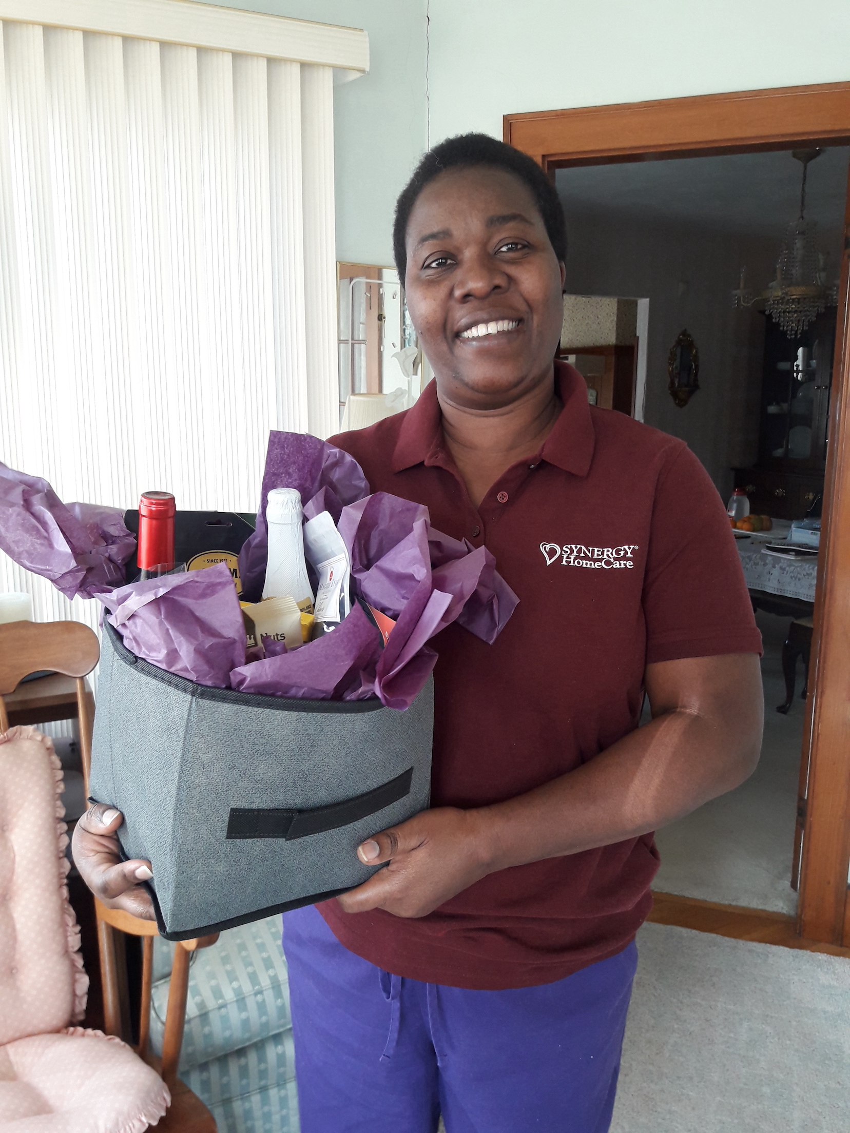 judith smiling holding a gift basket