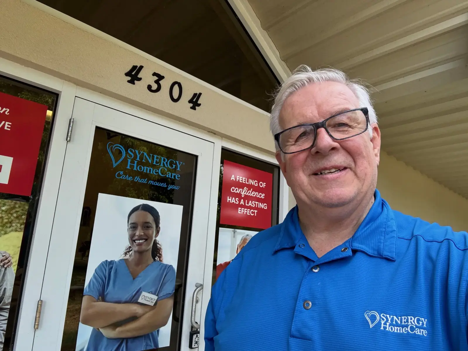 Owner Ken Gregson in front of SYNERGY office