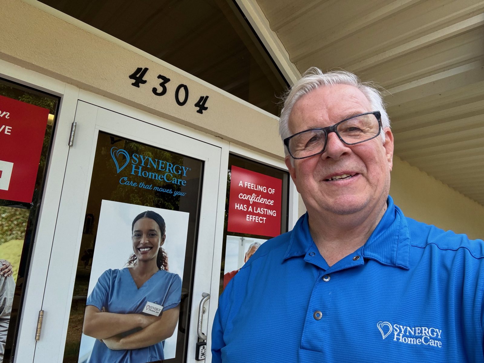 Owner Ken Gregson in front of SYNERGY office