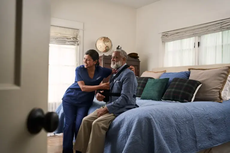 SYNERGY HomeCare caregiver helping client get dressed