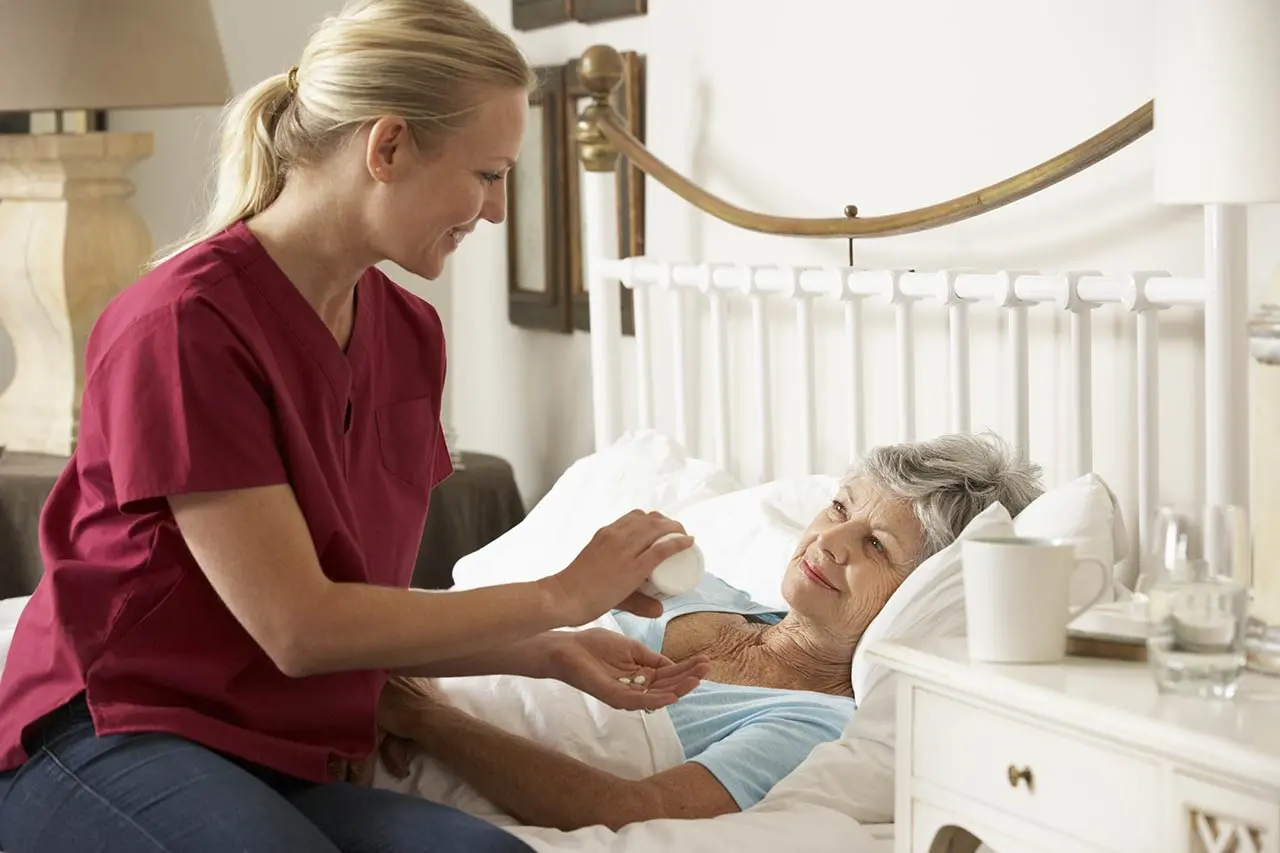 SYNERGY HomeCare caregiver helping client take medication