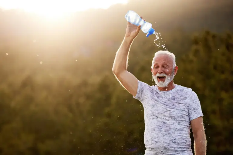 Senior Man Pours Water On Head in Heat (1)