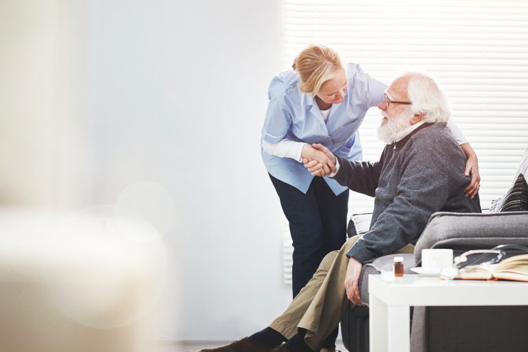 Mature, loving caregiver caring for a senior patient at an assisted living home. Healthcare worker comforting a confused man suffering with alzheimer's or dementia, showing kindness and support