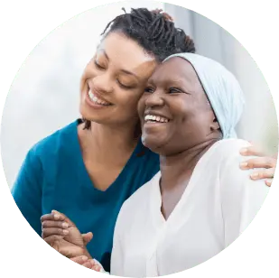 two women embracing each other and smiling