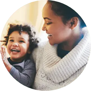 mother looking at her child while both are smiling with joy
