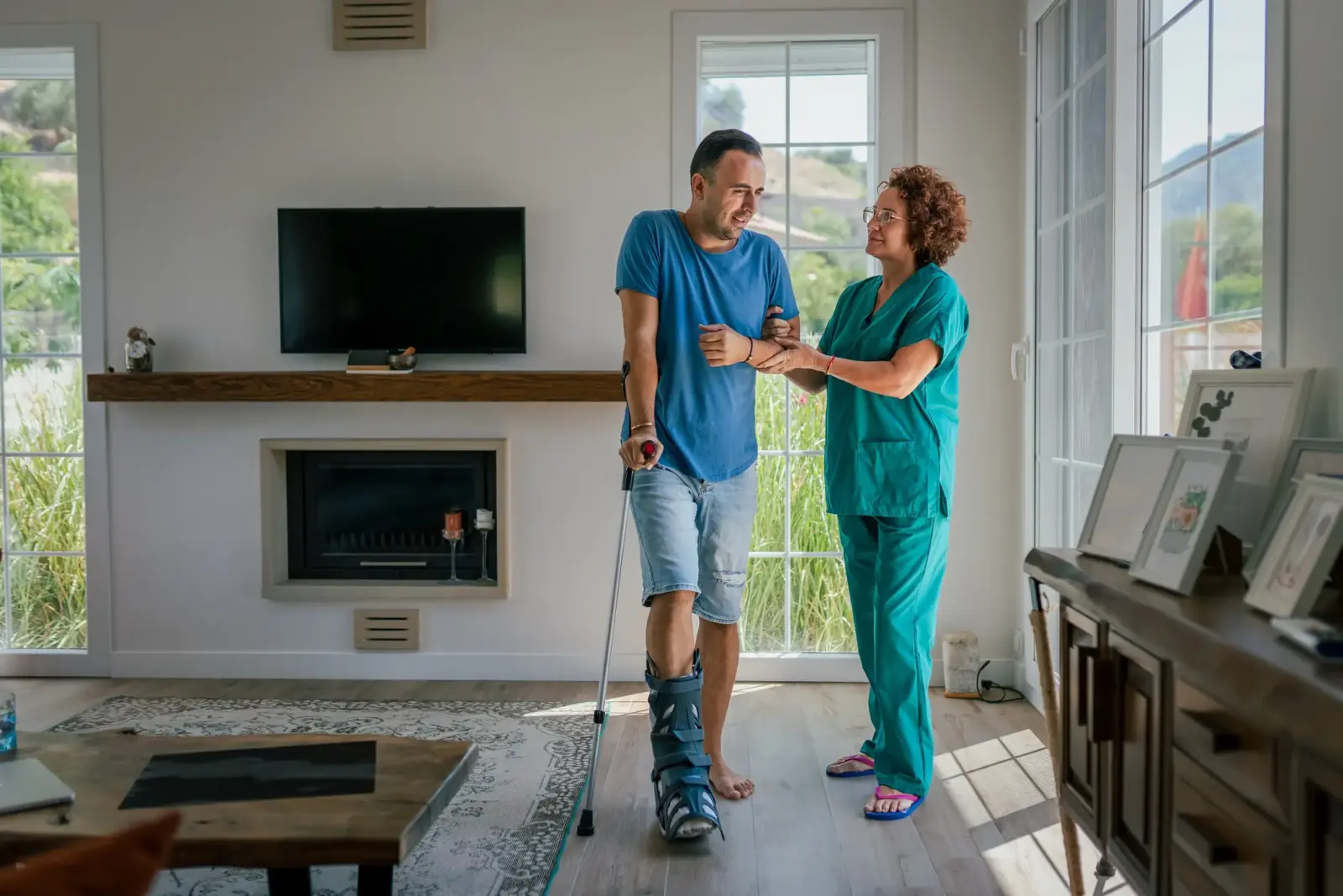Nurse helping Young man with physical therapy in his home