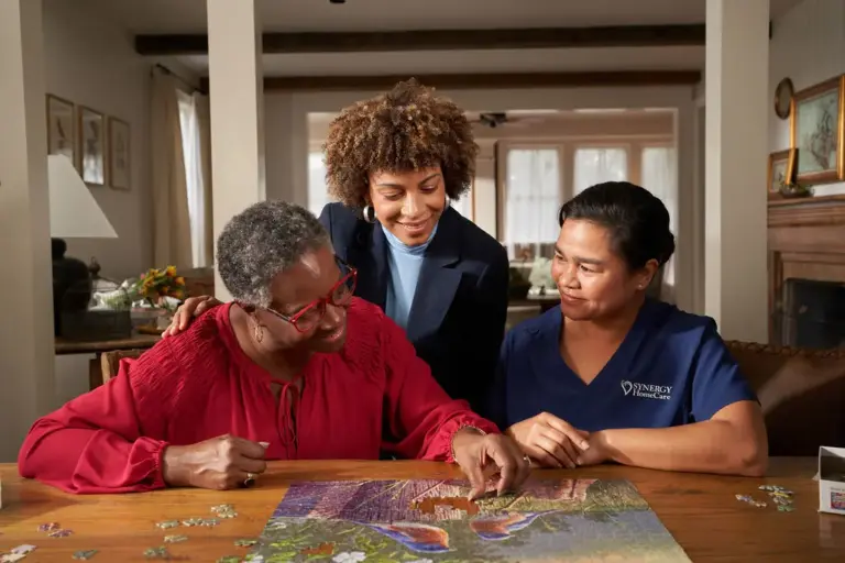 SYNERGY HomeCare Caregiver completing a puzzle to help with memory care.