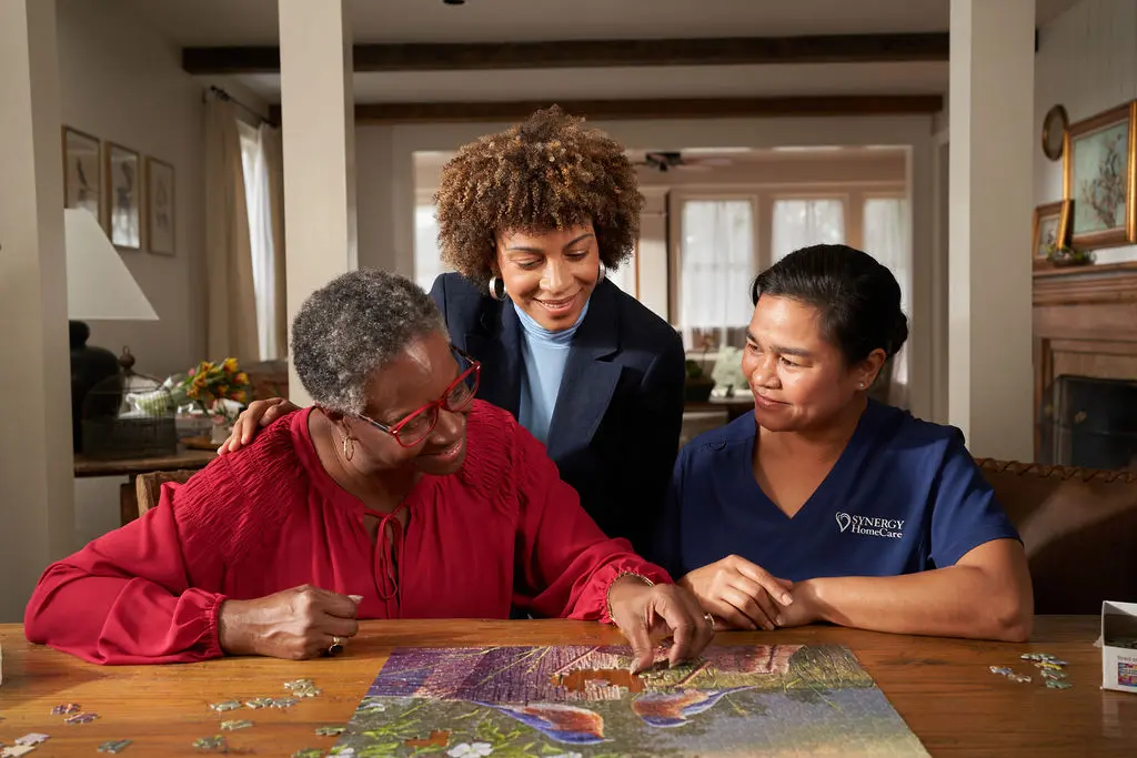 SYNERGY HomeCare Caregiver completing a puzzle to help with memory care.