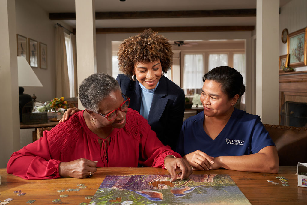 SYNERGY HomeCare Caregiver completing a puzzle to help with memory care.