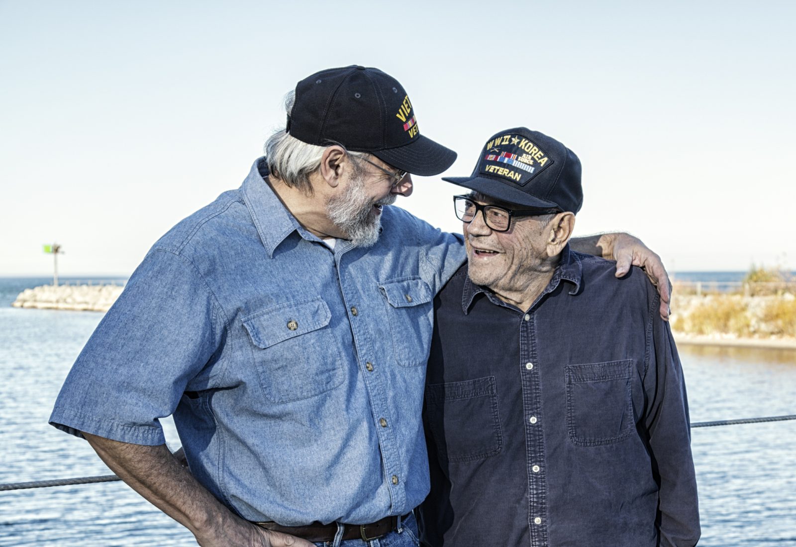 Two Generations of USA Military War Veterans Sharing a Laugh