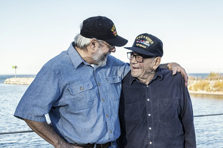Two Generations of USA Military War Veterans Sharing a Laugh