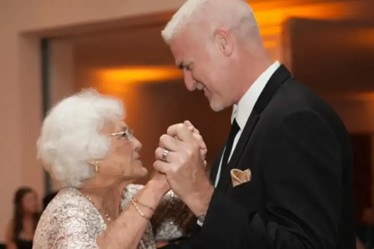 Photo of Kurt dancing at a wedding with his 90 year old mother