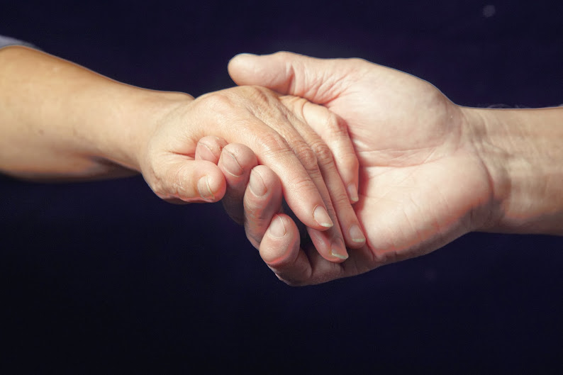 Two hands holding each other