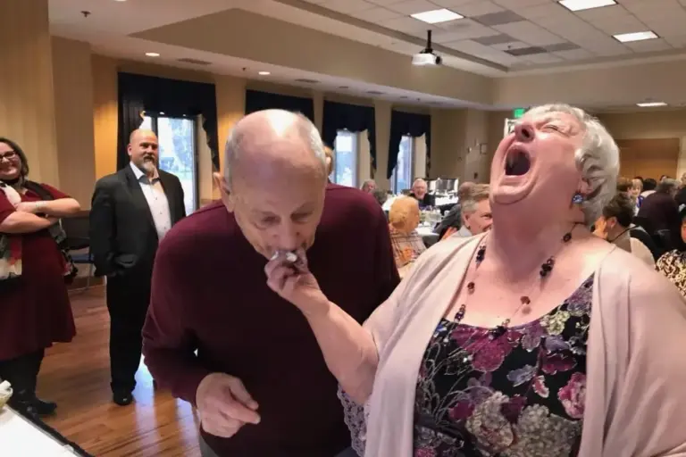 kay feeds harry a bite of wedding cake while laughing hysterically