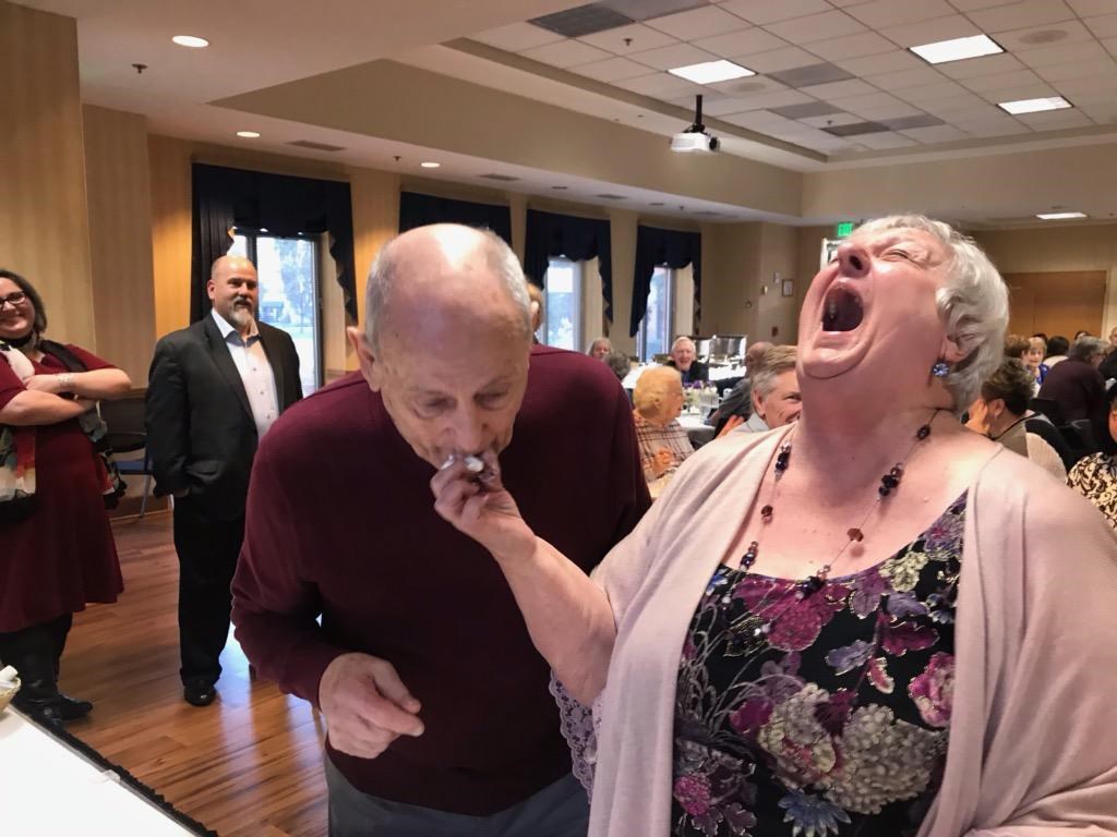 kay feeds harry a bite of wedding cake while laughing hysterically