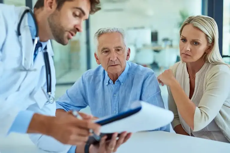 doctor giving results to senior man and his medical advocate woman