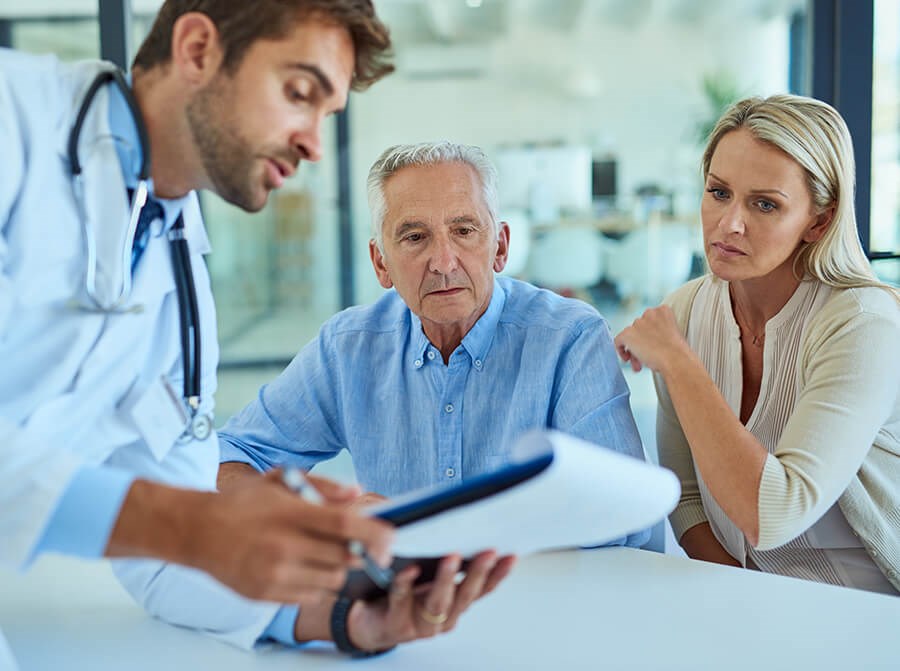 doctor giving results to senior man and his medical advocate woman