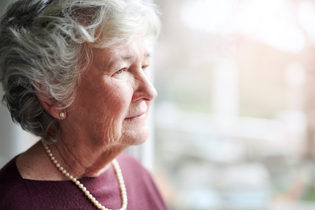 senior woman looking out the window
