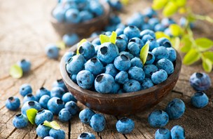 bigstock-blueberry-on-wooden-table-back-97797563.jpg