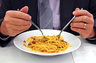 bigstock-businessman-eating-during-work-19002944.jpg