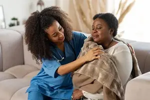 bigstock-caring-curly-nurse-giving-warm-296799103.jpg