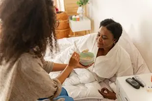 bigstock-nurse-giving-some-porridge-for-296806930.jpg