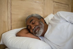 bigstock-senior-man-sleeping-on-bed-in-193664275-1.jpg