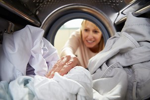 bigstock-woman-doing-laundry-reaching-i-78000665.jpg